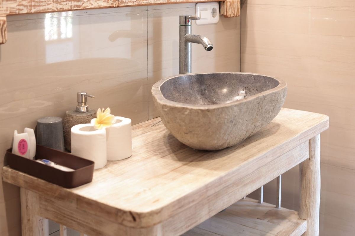 A river-stone basin in one of the bathrooms